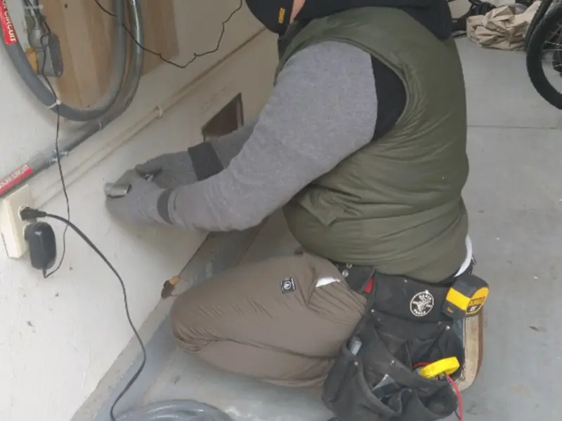 Electrician performing outlet wiring in a Forty Fort garage